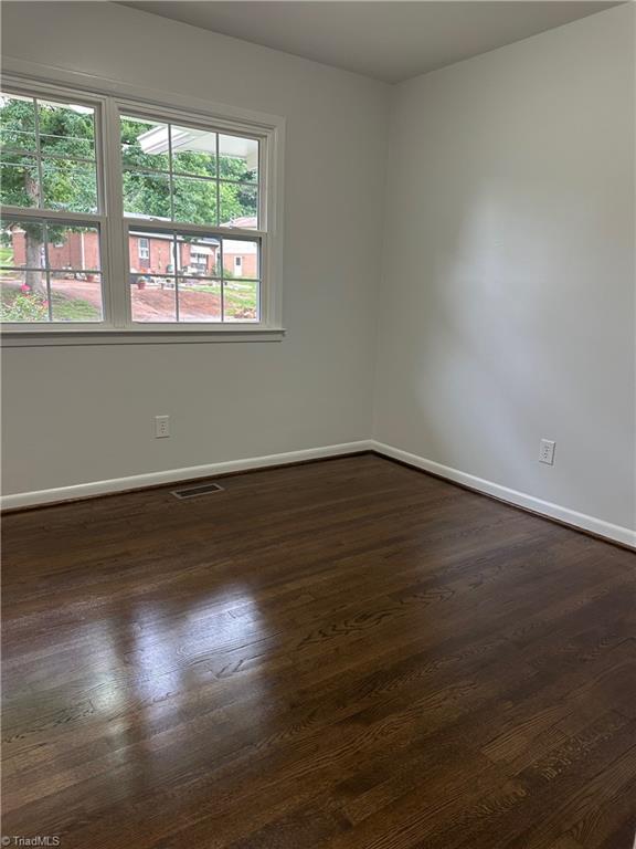 1230 W Sedgefield Dr, Winston-Salem, NC 27107 - empty room featuring baseboards and dark wood finished floors