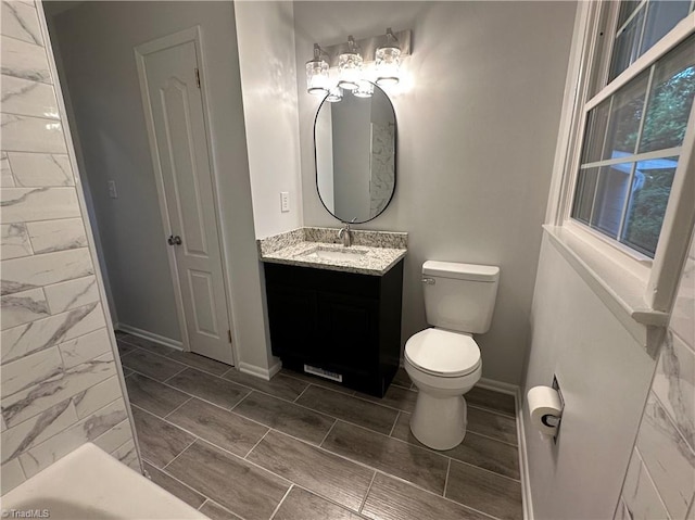 1230 W Sedgefield Dr, Winston-Salem, NC 27107 - full bathroom featuring vanity, toilet, and baseboards