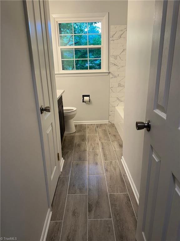 1230 W Sedgefield Dr, Winston-Salem, NC 27107 - full bathroom with vanity, wood tiled floors, and toilet