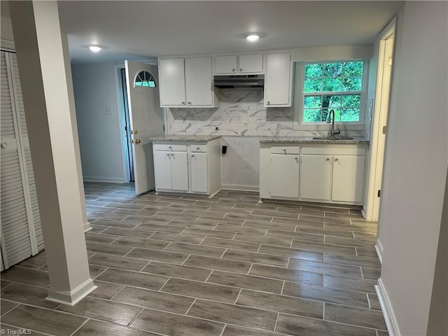 1230 W Sedgefield Dr, Winston-Salem, NC 27107 - kitchen with under cabinet range hood, wood tiled floors, a sink, and baseboards