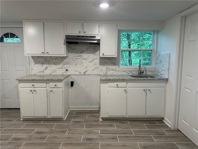 1230 W Sedgefield Dr, Winston-Salem, NC 27107 - kitchen with a sink, under cabinet range hood, white cabinets, wood finish floors, and recessed lighting