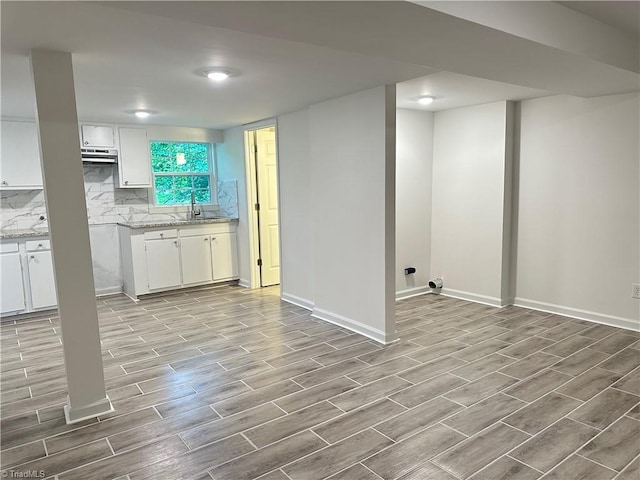 1230 W Sedgefield Dr, Winston-Salem, NC 27107 - kitchen featuring wood finished floors, white cabinets, a sink, and baseboards