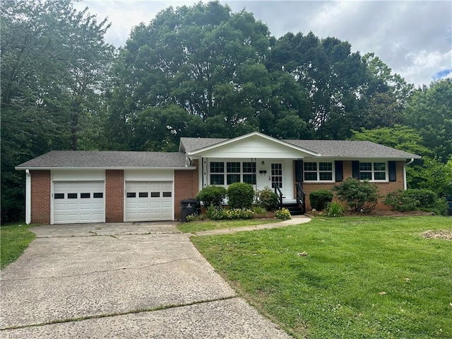 1230 W Sedgefield Dr, Winston-Salem, NC 27107 - ranch-style house with concrete driveway, brick siding, a front lawn, and an attached garage