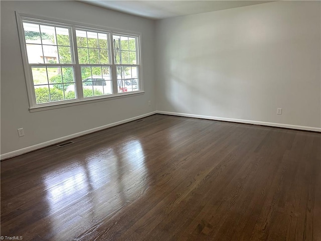 1230 W Sedgefield Dr, Winston-Salem, NC 27107 - spare room featuring baseboards and dark wood finished floors