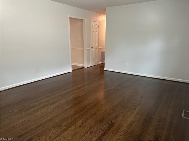1230 W Sedgefield Dr, Winston-Salem, NC 27107 - spare room featuring baseboards and dark wood-style flooring