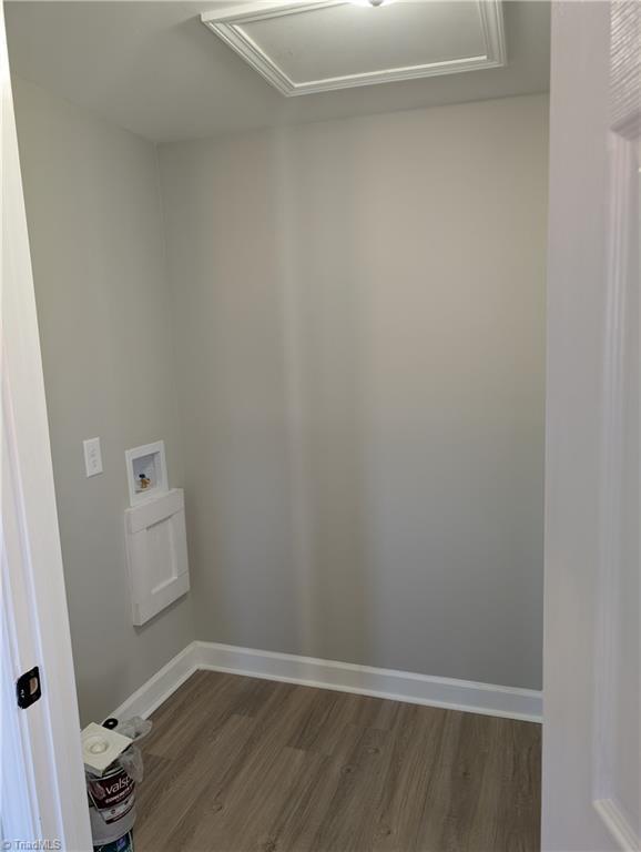 laundry room featuring hookup for a washing machine and dark hardwood / wood-style flooring