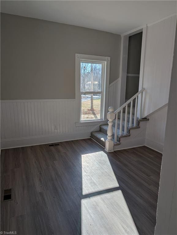 empty room featuring dark wood-type flooring