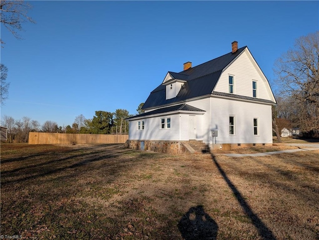 rear view of house with a lawn