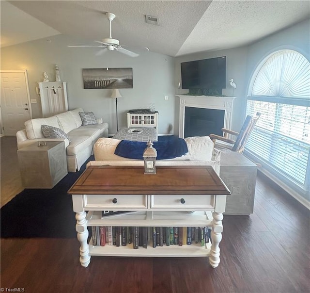 1620 Cherry Blossom Ln Unit 301, Winston-Salem, NC 27127 - living area featuring vaulted ceiling, wood finished floors, a ceiling fan, a textured ceiling, and a fireplace