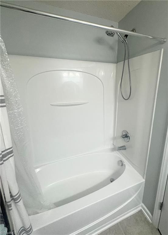 1620 Cherry Blossom Ln Unit 301, Winston-Salem, NC 27127 - bathroom featuring shower / bathtub combination with curtain, a textured ceiling, and tile patterned floors