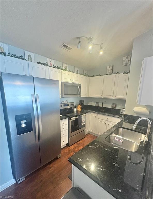 1620 Cherry Blossom Ln Unit 301, Winston-Salem, NC 27127 - kitchen with stainless steel appliances, dark wood-style flooring, white cabinetry, and a textured ceiling