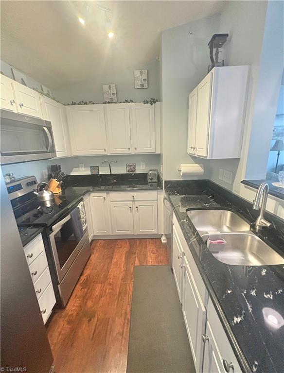 1620 Cherry Blossom Ln Unit 301, Winston-Salem, NC 27127 - kitchen featuring appliances with stainless steel finishes, dark wood finished floors, and white cabinetry
