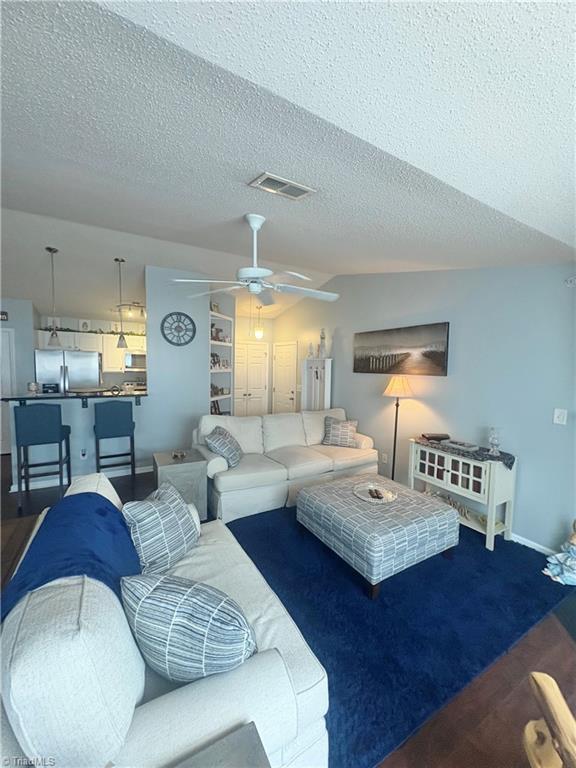 1620 Cherry Blossom Ln Unit 301, Winston-Salem, NC 27127 - living area featuring ceiling fan, a textured ceiling, and vaulted ceiling