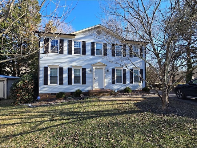 colonial inspired home with a front lawn