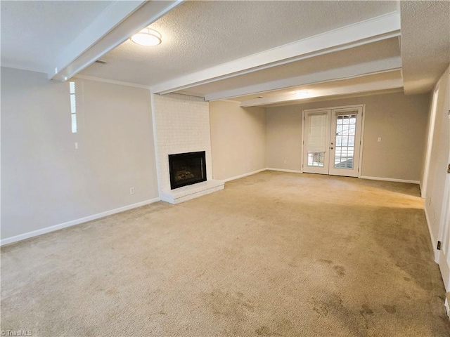 interior space featuring a textured ceiling, carpet, french doors, ornamental molding, and a brick fireplace