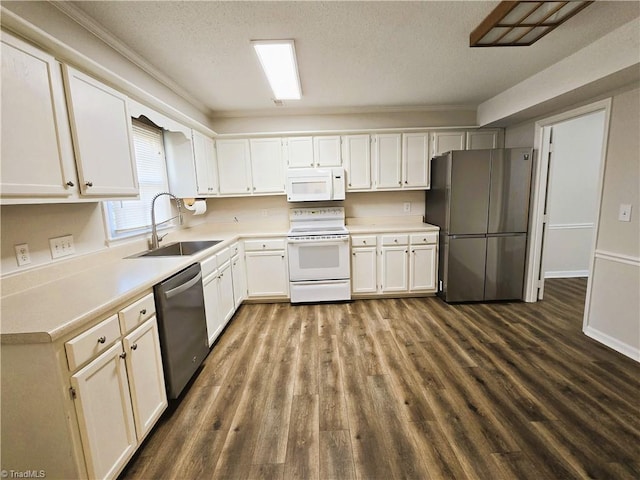 kitchen featuring appliances with stainless steel finishes, sink, white cabinets, a textured ceiling, and dark hardwood / wood-style floors