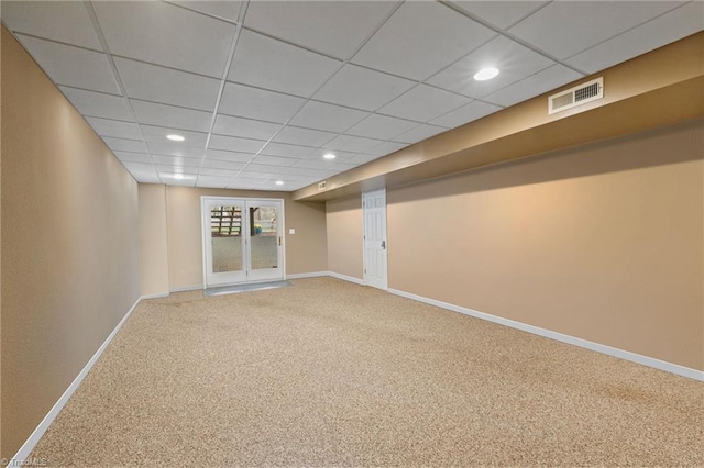 basement featuring baseboards, visible vents, a drop ceiling, carpet, and recessed lighting