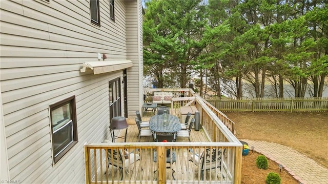 wooden deck featuring outdoor dining space and a fenced backyard