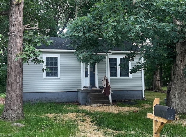 view of front of home featuring roof with shingles and crawl space