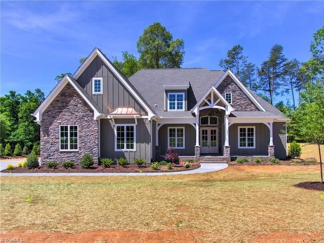 craftsman house with french doors and a front yard