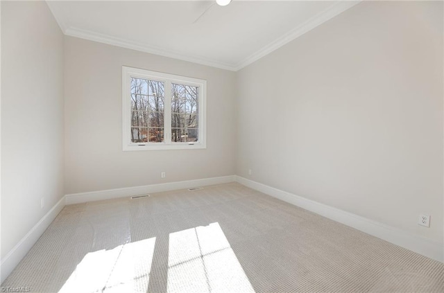 unfurnished room featuring crown molding and light carpet