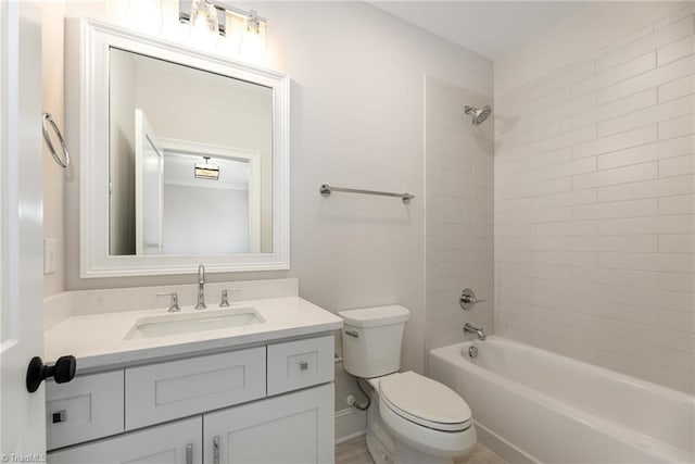 full bathroom with tiled shower / bath, vanity, and toilet