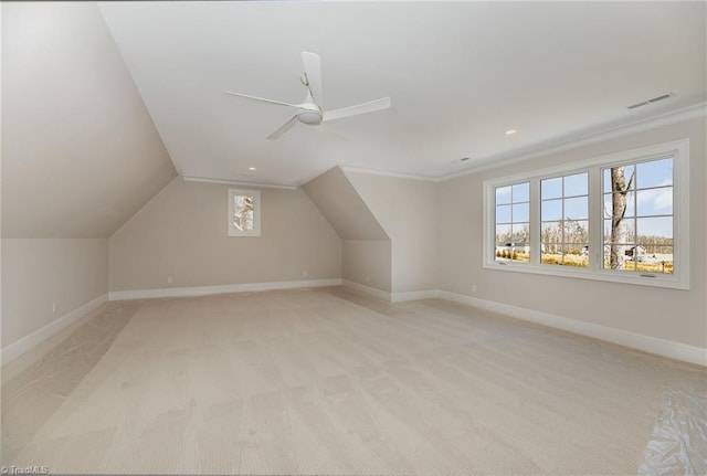 bonus room with vaulted ceiling, light colored carpet, and ceiling fan