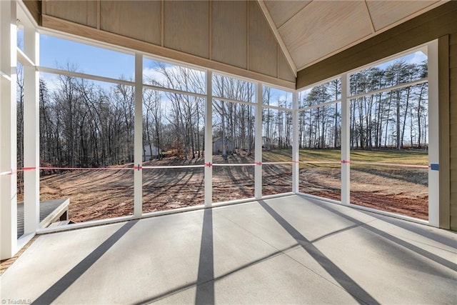 unfurnished sunroom with lofted ceiling