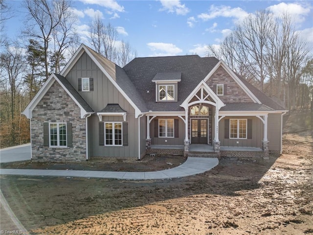 craftsman inspired home featuring a porch and french doors