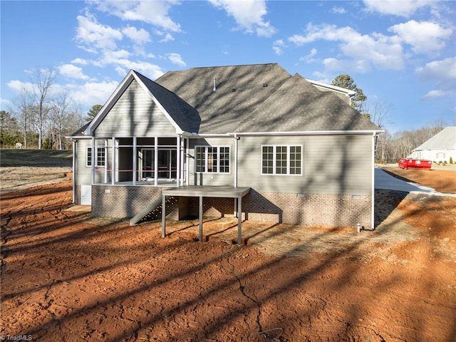 rear view of house featuring a sunroom