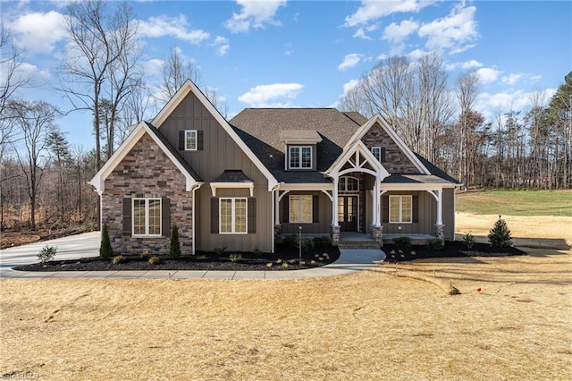 7621 Pemberley Dr, Oak Ridge, NC 27310 - craftsman inspired home with covered porch, a front lawn, board and batten siding, and roof with shingles