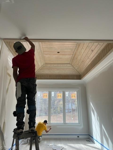 room details with crown molding, wood ceiling, and a tray ceiling