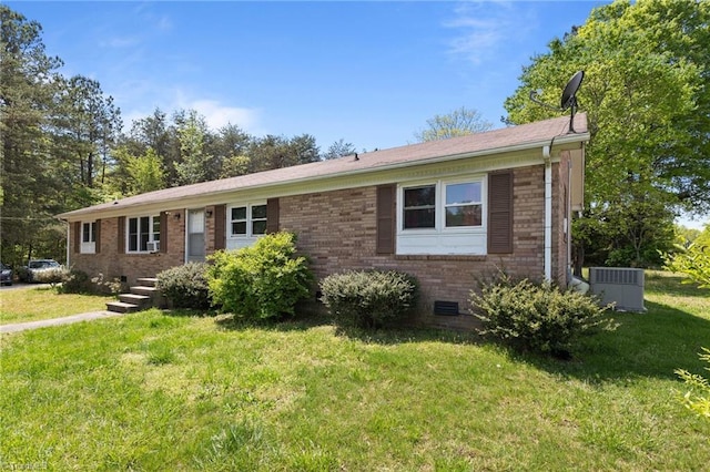 single story home with central air condition unit, a front lawn, brick siding, and crawl space