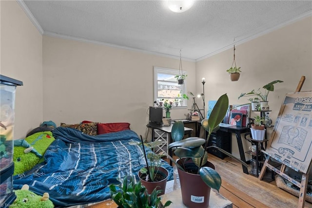 bedroom with wood finished floors, a textured ceiling, and ornamental molding