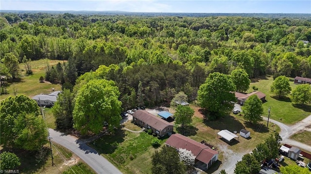 bird's eye view with a wooded view