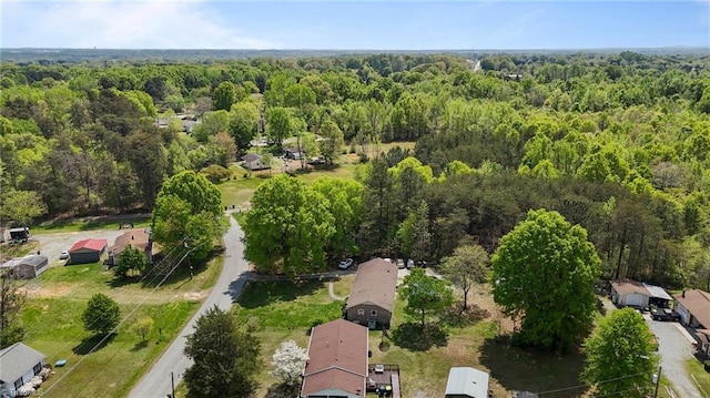 birds eye view of property with a wooded view