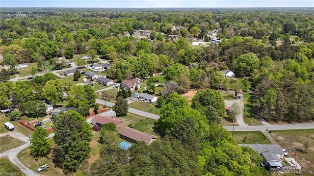 drone / aerial view with a wooded view