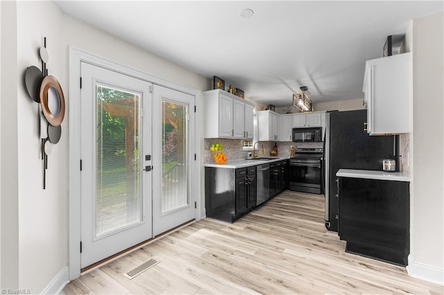 kitchen with visible vents, light countertops, a sink, appliances with stainless steel finishes, and backsplash