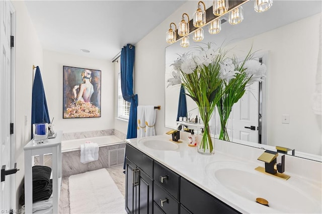 full bathroom featuring double vanity, a sink, and a garden tub