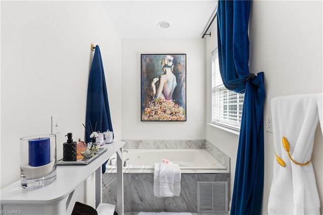 full bathroom featuring visible vents and a garden tub