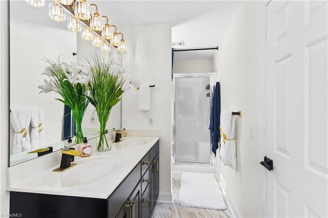 full bath with double vanity, a sink, and a stall shower