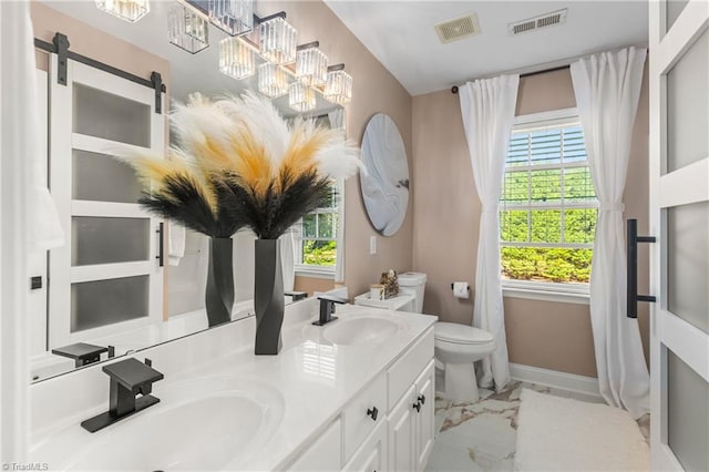 full bathroom with a sink, toilet, and visible vents