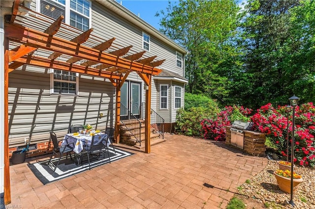 view of patio / terrace featuring entry steps, a pergola, and exterior kitchen