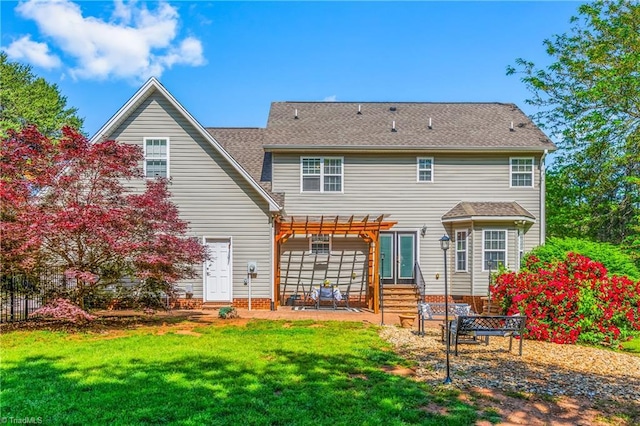 back of house featuring fence, a pergola, a patio, entry steps, and a yard