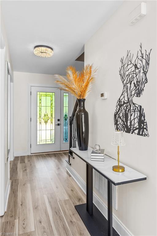 interior space featuring baseboards, stairs, and wood finished floors