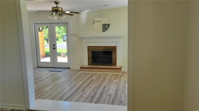 313 Farmstead Rd, King, NC 27021 - unfurnished living room featuring french doors, ceiling fan, wood finished floors, and a glass covered fireplace
