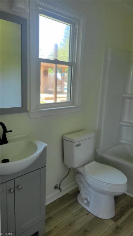 313 Farmstead Rd, King, NC 27021 - bathroom featuring vanity, wood finished floors, and bathing tub / shower combination