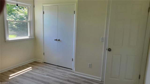 313 Farmstead Rd, King, NC 27021 - unfurnished bedroom featuring light wood finished floors and a closet