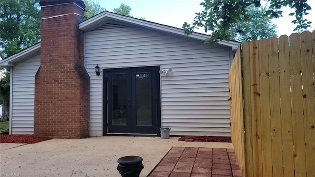 313 Farmstead Rd, King, NC 27021 - property entrance with french doors, a chimney, and a patio area