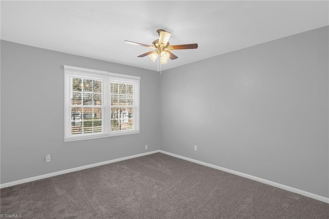 carpeted spare room featuring ceiling fan